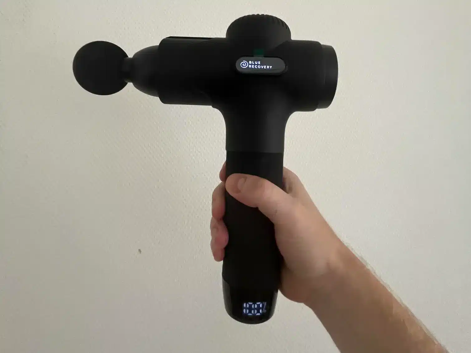 afbeelding van de blue recovery massage gun in mijn hand